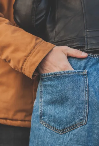 person in blue denim jeans and brown jacket
