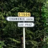 directional signs beside green trees